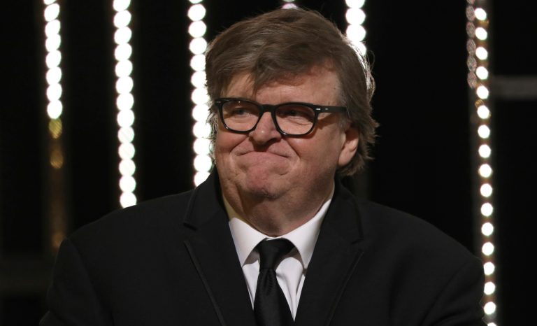 Director Michael Moore presents the jury prize during the awards ceremony at the 72nd international film festival, Cannes, southern France, Saturday, May 25, 2019. 