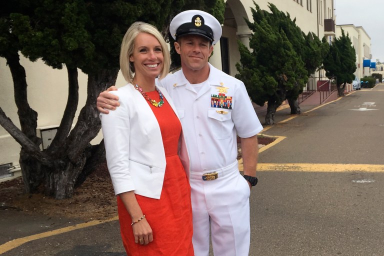 Navy Special Operations Chief Edward Gallagher embraces his wife, Andrea Gallagher, after leaving a military courtroom on Naval Base San Diego, Thursday, May 30, 2019, in San Diego. The decorated Navy SEAL facing a murder trial in the death of an Islamic State prisoner was freed Thursday from custody after a military judge cited interference by prosecutors. (AP Photo/Julie Watson)