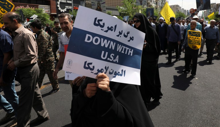 A demonstrator holds an anti-U.S. placard during the annual Quds, or Jerusalem Day rally in Tehran, Iran, Friday, May 31, 2019. Thousands of Iranians rallied Friday to mark Quds, or Jerusalem Day, which will see demonstrations across the Mideast as the Trump administration tries to offer an Israeli-Palestinian peace plan.