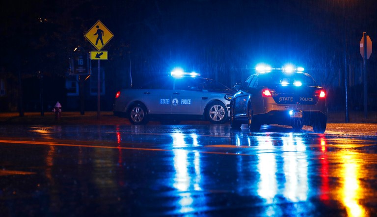 Virginia State Police vehicles block a street near the scene of a shooting at a municipal building in Virginia Beach, Va.