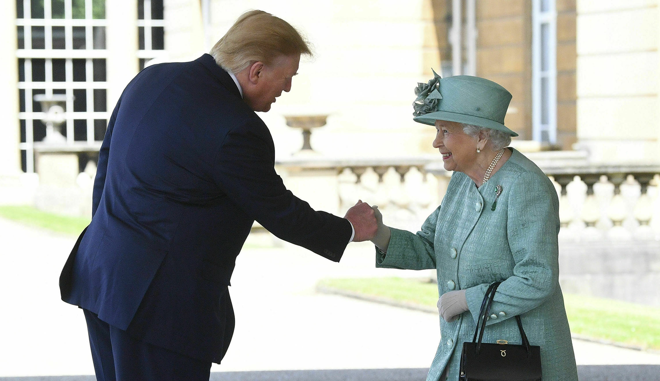 Queen a good sport as Trump breaches etiquette — twice