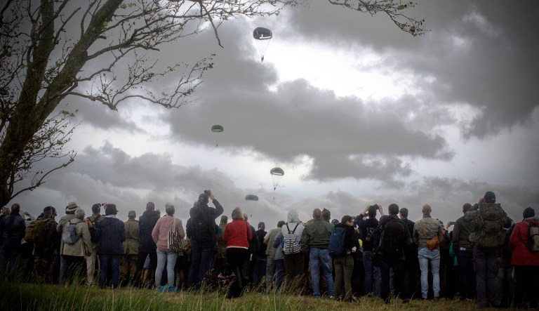 Spectators watch parachutists jumping just as soldiers did 75 years ago for D-Day in Carentan, Normandy.
