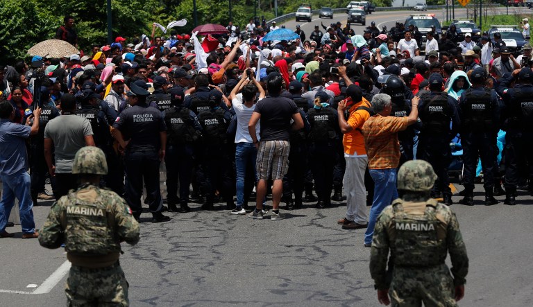 Mexican authorities stop a migrant caravan that had earlier crossed the Mexico-Guatemala border, near Metapa, Chiapas state, Mexico, Wednesday, June 5, 2019.