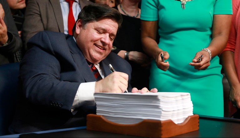 Gov. J.B. Pritzker signs the state budget and legislation related to a graduated income tax in Illinois, during a bill signing Wednesday, June 5, 2019 at the Thompson Center in Chicago.