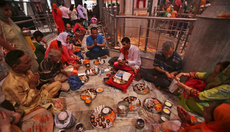 Kashmiri Hindus, known as Pandits, perform rituals during the annual festival at Kheer Bhawani temple in Jammu, India. 
