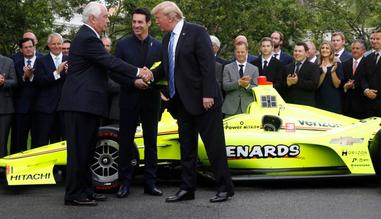President Donald Trump shakes hands with team owner Roger Penske, left, and driver Simon Pagenaud on the South Lawn at the White House, Monday, June 10, 2019, in Washington as he honors Team Penske for the 2019 Indianapolis 500 win.