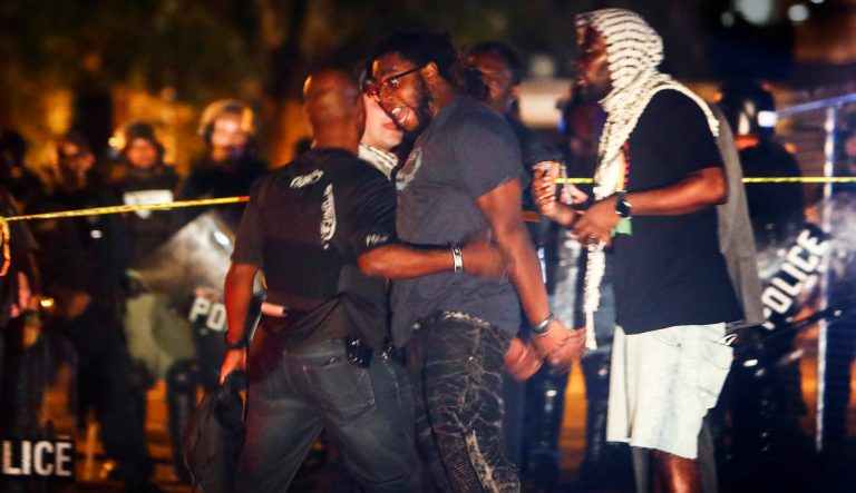 Protesters take to the streets of the Frayser community in anger against the shooting of a youth by U.S. Marshals earlier in the evening, Wednesday, June 12, 2019, in Memphis, Tenn. Dozens of protesters clashed with law enforcement, throwing stones and tree limbs until authorities broke up the angry crowd with tear gas. 