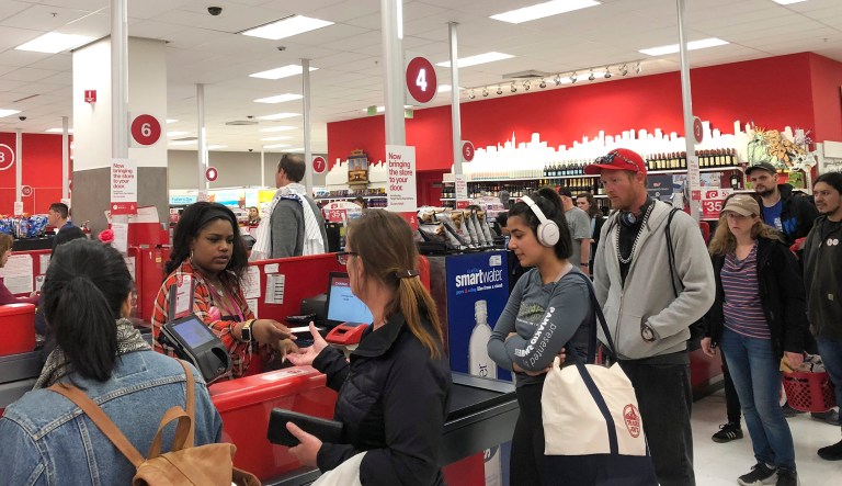Customers wait on a long checkout line at a Target store in San Francisco.
