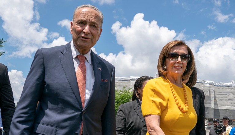 Senate Minority Leader Chuck Schumer, D-New York, left, and Speaker of the House Nancy Pelosi, D-California, walk at the Capitol in Washington.