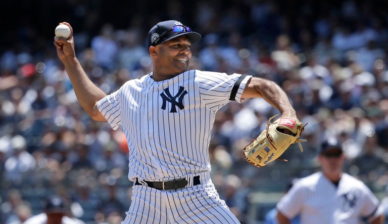 Former New York Yankee Mariano Rivera pitches during the Old Timer's Day game at Yankee Stadium in New York. 