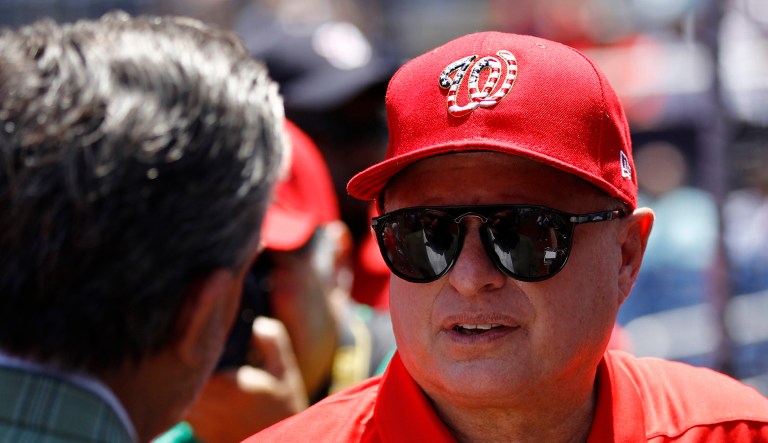 Washington Nationals owner Mark Lerner chats on the field before a baseball game.