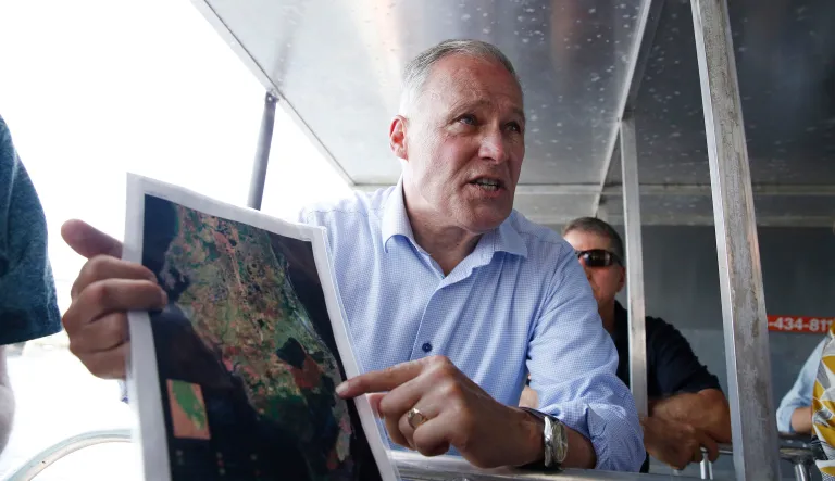 Democratic presidential candidate Washington Gov. Jay Inslee points to a map of the everglades on an airboat ride through the everglades at the Everglades Holiday Park, Monday, June 24, 2019 in Fort Lauderdale, Fla.