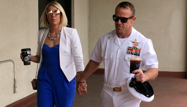Navy Special Operations Chief Edward Gallagher, right, walks with his wife, Andrea Gallagher as they arrive to military court on Naval Base San Diego, Wednesday, June 26, 2019, in San Diego. Trial continues in the court-martial of the decorated Navy SEAL, who is accused of stabbing to death a wounded teenage Islamic State prisoner and wounding two civilians in Iraq in 2017. He has pleaded not guilty to murder and attempted murder, charges that carry a potential life sentence.
