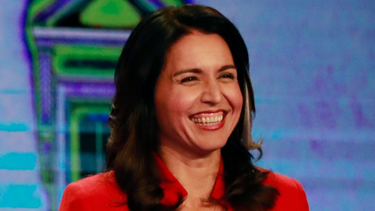 Democratic presidential candidates Sen. Amy Klobuchar, D-Minn., and Rep. Tulsi Gabbard, D-Hawaii, smile during a Democratic primary debate hosted by NBC News at the Adrienne Arsht Center for the Performing Arts, Wednesday, June 26, 2019, in Miami. (AP Photo/Wilfredo Lee)