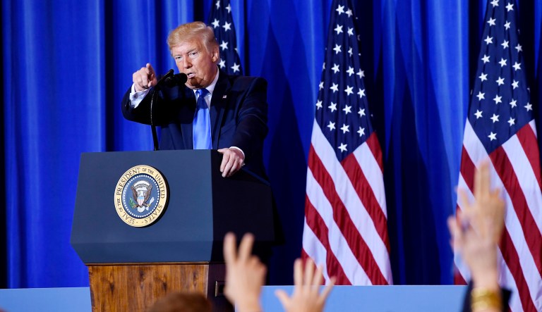 President Trump calls on a reporter to ask a question during a news conference.