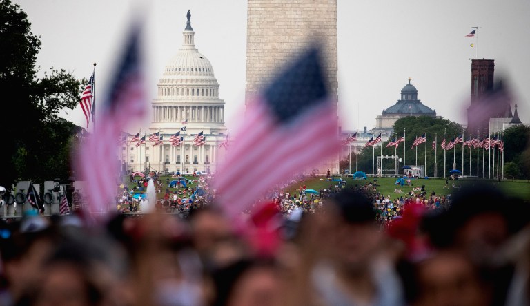 The Capitol Dome and the Washington Monument are visible as guests gather along the Reflecting Pool for President Trump's 'Salute to America' event honoring service branches on Independence Day in Washington.