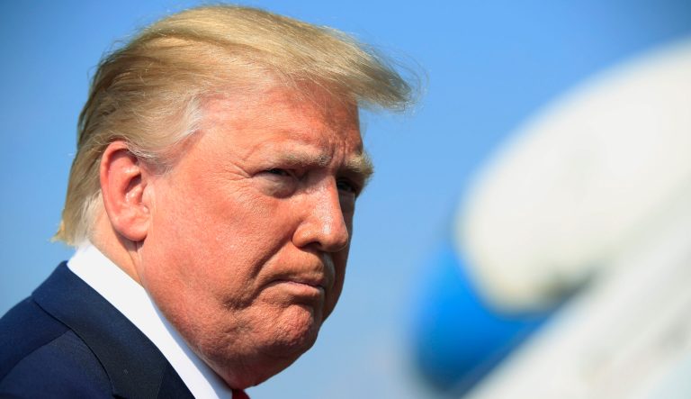 President Donald Trump listens to a reporter as he speaks at Morristown Municipal Airport in Morristown, N.J., on their way returning back to the White House Sunday, July 7, 2019. 