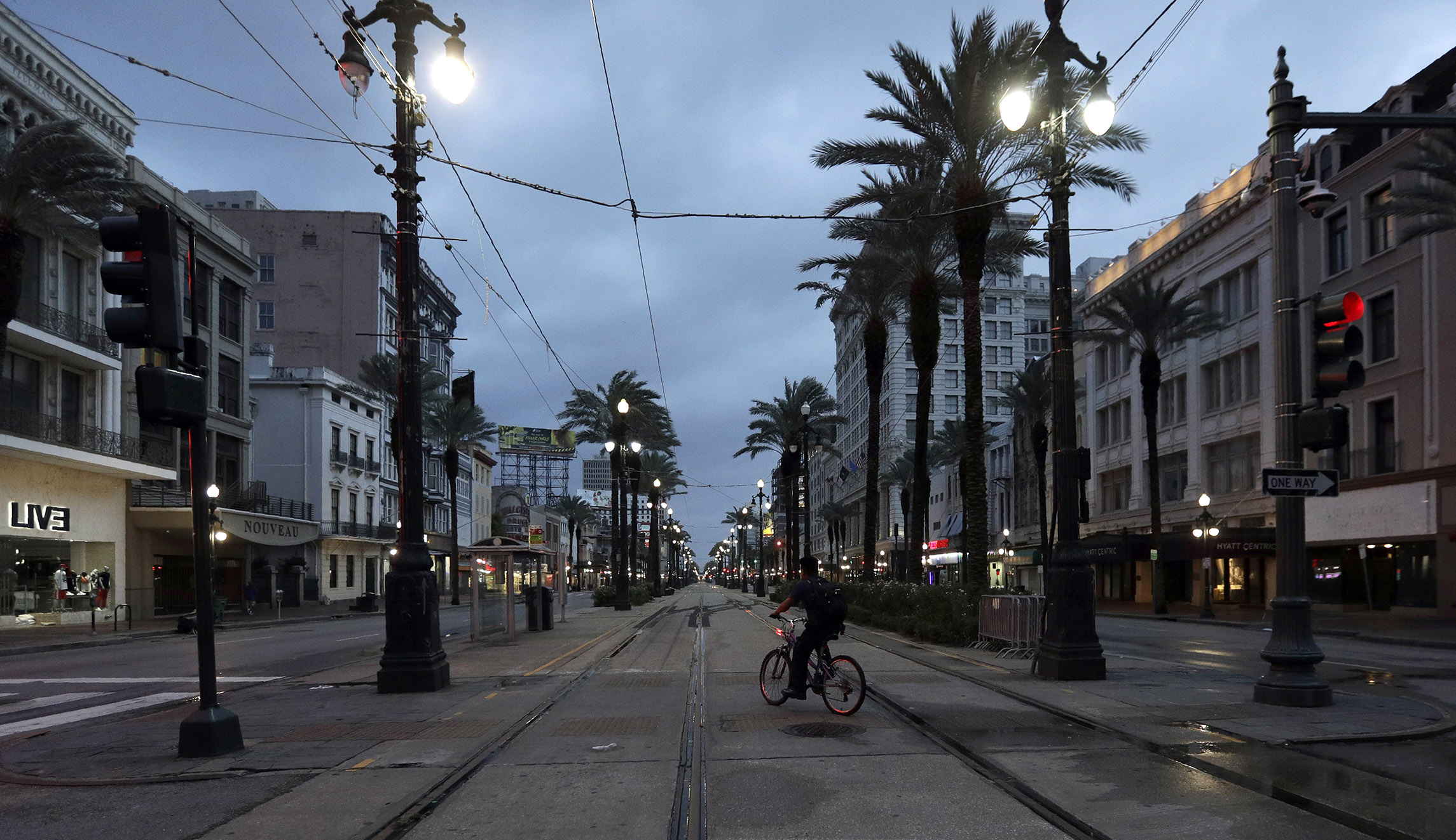 A man rides a bicycle on Canal Street on Saturday in New Orleans as Tropical Storm Barry nears landfall.