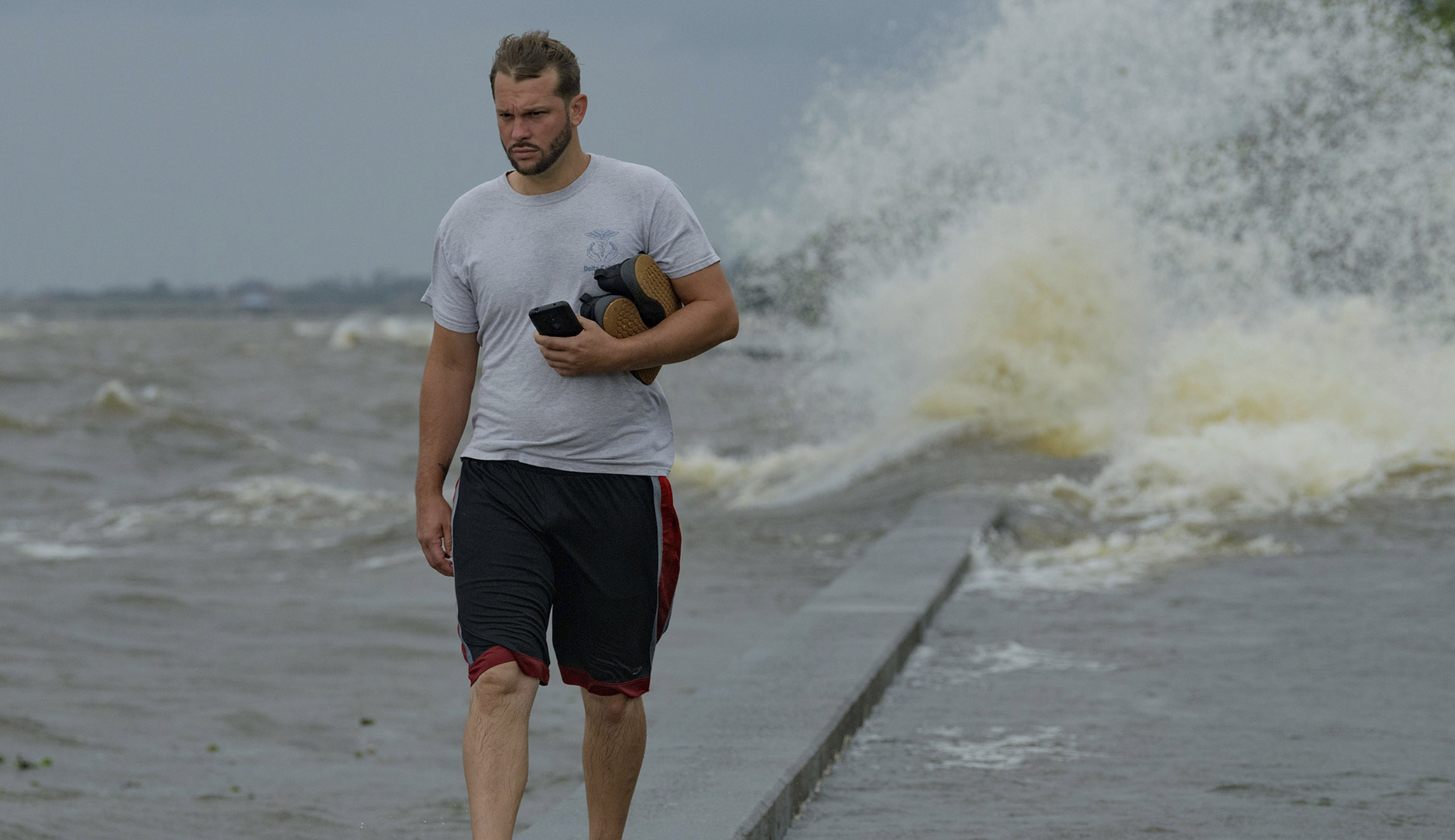 Wesley Vinson wades through storm surge from Lake Pontchartrain on Lakeshore Drive in Mandeville, La., as Hurricane Barry approaches Saturday, July 13, 2019. Barry had strengthened into a Category 1 hurricane by Saturday morning, with maximum sustained winds of 75 mph (120 kph), the National Hurricane Center said.