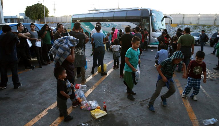 Migrants wait outside at an immigration center on the International Bridge 1, in Nuevo Laredo, Mexico, Tuesday, July 16, 2019. A U.S. policy to make asylum seekers wait in Mexico while their cases wind through clogged U.S. immigration courts has also expanded to the violent city of Nuevo Laredo. 