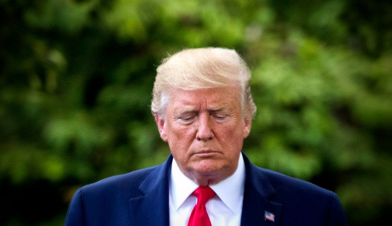 President Trump walks to speak with reporters on the South Lawn of the White House before departing.