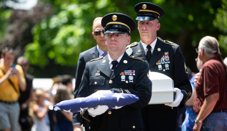 U.S. Army members carry a folded flag along with the remains of Vietnam War veteran Wayne Wilson during his memorial service at the Silverbrook Cemetery in Niles, Mich. on Wednesday, July 17, 2019. 