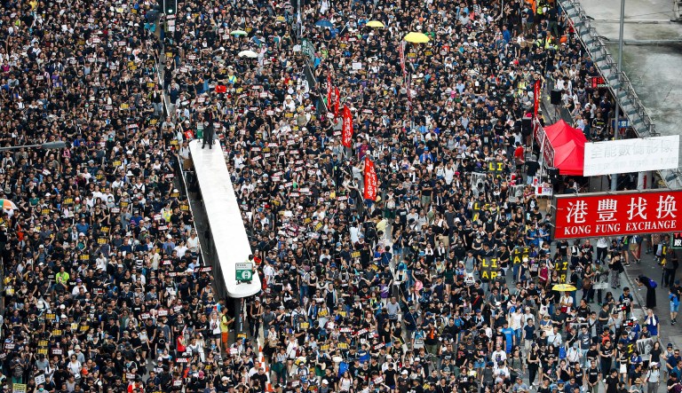 Protesters take part in a march on a street in Hong Kong.