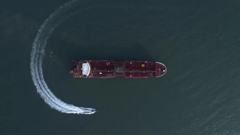 In this Sunday, July 21, 2019 photo, an aerial view shows a speedboat of the Islamic Revolutionary Guard Corp moving around the British-flagged oil tanker Stena Impero, which was seized in the Strait of Hormuz by the Guard, in the Iranian port of Bandar Abbas. | (Morteza Akhoondi/AP)