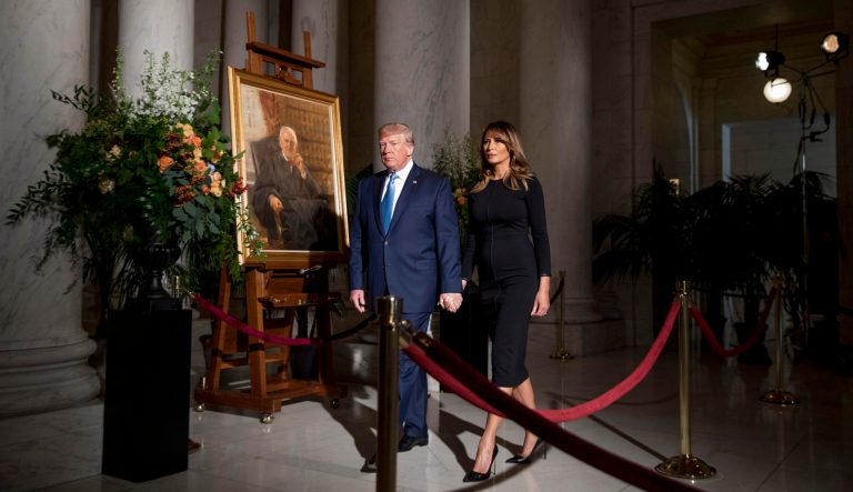 President Donald Trump and first lady Melania Trump walk past a painting of the late Supreme Court Justice John Paul Stevens after they pay their respects as he lies in repose in the Great Hall of the Supreme Court in Washington, Monday, July 22, 2019. 