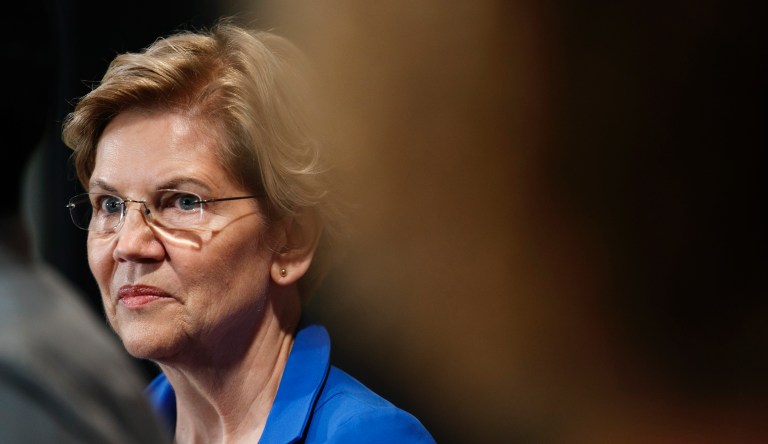 Sen. Elizabeth Warren, D-Mass., listens to a student talk about his student loan debt, on which he is still paying off the interest ten years after graduating, at at event with Warren and Rep. Jim Clyburn, D-S.C., about their bill to cancel student loan debt, Tuesday, July 23, 2019, on Capitol Hill in Washington.