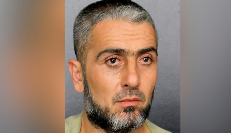 This July 8, 2019 photo made available by the Broward County Sheriff's Office shows Mohammed Omar Haji Mohammed under arrest. Federal courts record show that Mohammed, accused of attempting to slash a Walmart employee with scissors, now faces federal charges after allegedly threatening President Donald Trump while he was being arrested during the July 8 altercation. 