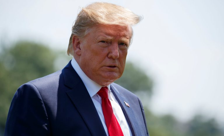 President Donald Trump looks over at the media as he arrives at the White House in Washington, Tuesday, July 30, 2019, as the returns from Virginia. 