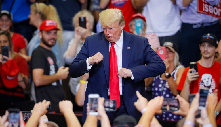 President Trump gestures to the crowd before exiting a campaign rally at U.S. Bank Arena in Cincinnati.