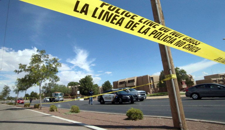 Police tape strung across an intersection behind the scene of a shooting at a shopping mall in El Paso, Texas.