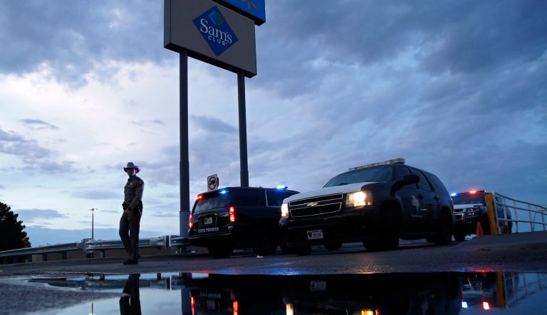 Law enforcement officials block a road at the scene of a mass shooting at a shopping complex Sunday, Aug. 4, 2019, in El Paso, Texas. 