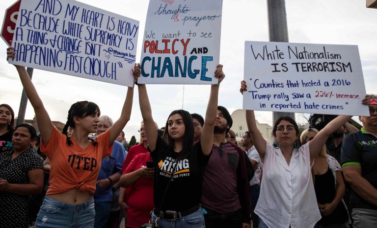 From left, Carla Rodriguez, Jena Marcus and Sofia Hinojosa hold signs during a silent march Sunday, Aug. 4, 2019, in honor to the victims of a mass shooting occurred in Walmart on Saturday, Aug. 3, 2019, in El Paso, Texas. 