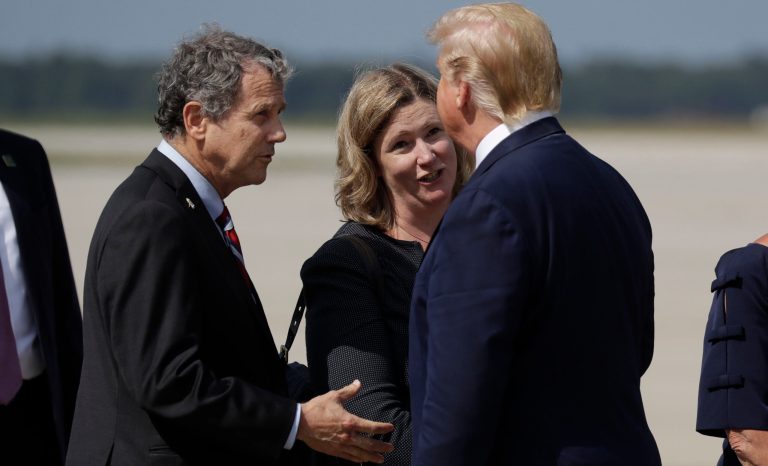 President Donald Trump is greeted by Dayton Mayor Nan Whaley and Sen. Sherrod Brown, D-Ohio, after arriving at Wright-Patterson Air Force Base to meet with people affected by the mass shooting in Dayton, Wednesday, Aug. 7, 2019, in Wright-Patterson Air Force Base, Ohio. 