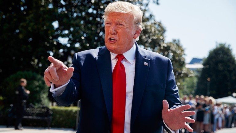 President Trump talks to reporters on the South Lawn of the White House in Washington.