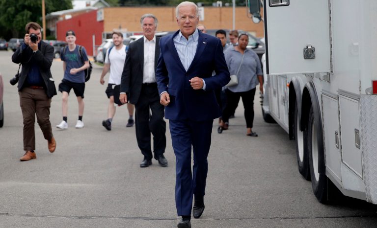 Former Vice President and Democratic presidential candidate Joe Biden runs into the building before speaking at the Iowa Democratic Wing Ding at the Surf Ballroom, Friday, Aug. 9, 2019, in Clear Lake, Iowa.