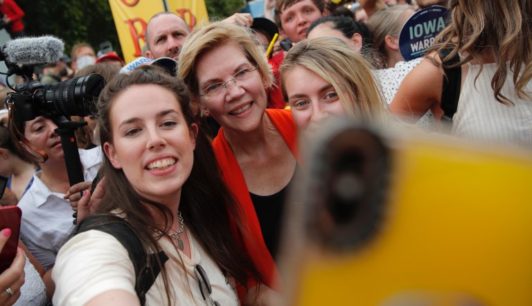 Democratic presidential candidate Sen. Elizabeth Warren, D-Mass., poses for a selfie at the Iowa State Fair, Saturday, Aug. 10, 2019, in Des Moines, Iowa. 
