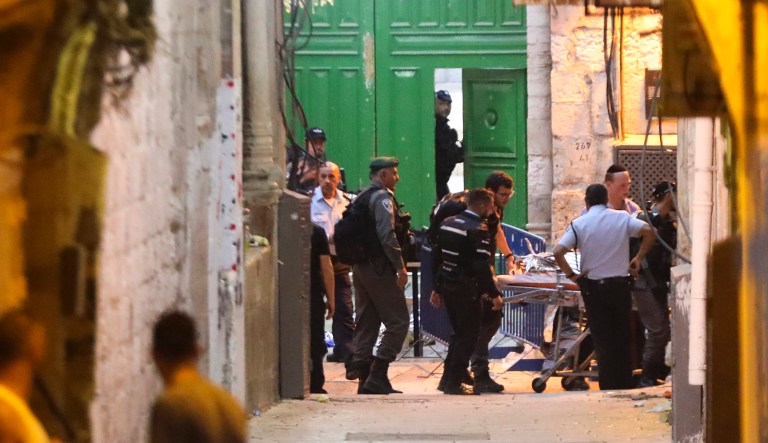 Israeli police remove a body of a Palestinian who was shot and killed after he allegedly attacked a policeman in Jerusalem's Old City on Thursday. One policeman was moderately injured in the stabbing attack, police said.