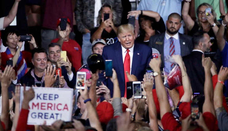 President Trump faces cheering supporters as he leaves a campaign rally in Manchester, N.H. 