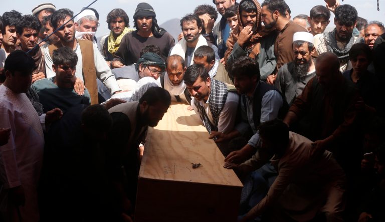 Afghans carry the body of a victim of the Dubai City wedding hall bombing during a mass funeral in Kabul, Afghanistan, Sunday, Aug.18, 2019. 