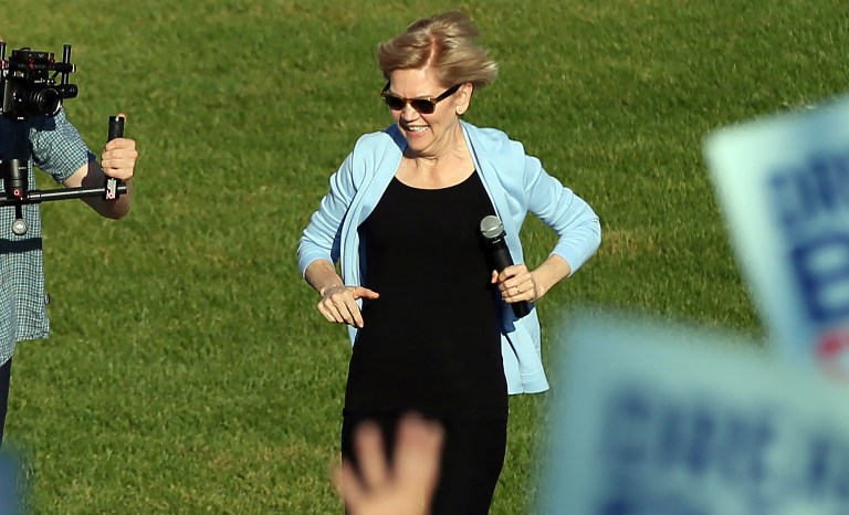 Democratic presidential candidate Elizabeth Warren, D-Mass., runs to the platform as she arrives to speak at a rally Monday, Aug. 19, 2019 at Macalaster College during a campaign appearance in St. Paul, Minn. 