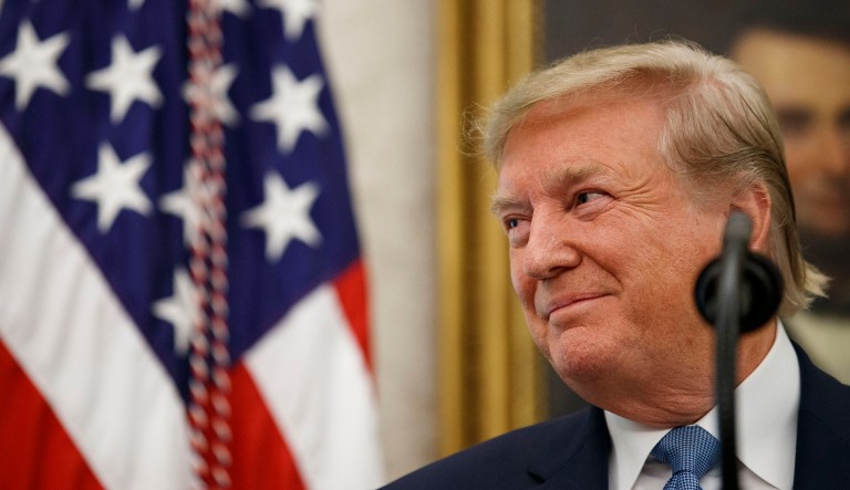 President Trump smiles while speaking.
