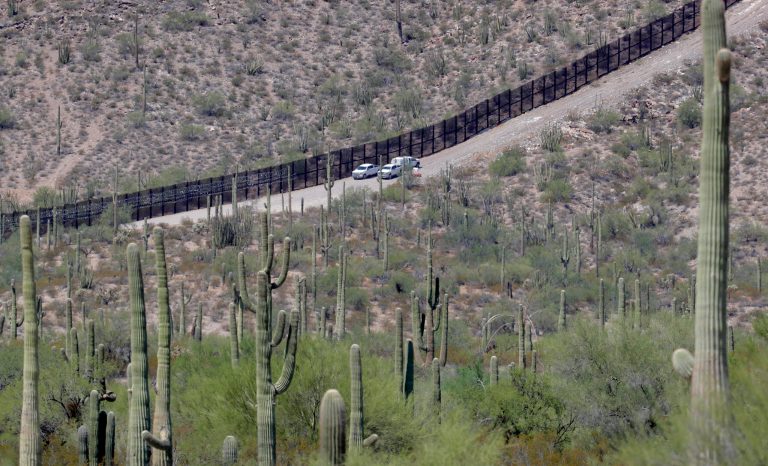 U.S. Customs and Patrol Patrol agents sit along a section of the international border wall that runs through Organ Pipe National Monument, Thursday, Aug. 22, 2019 in Lukeville, Ariz. 