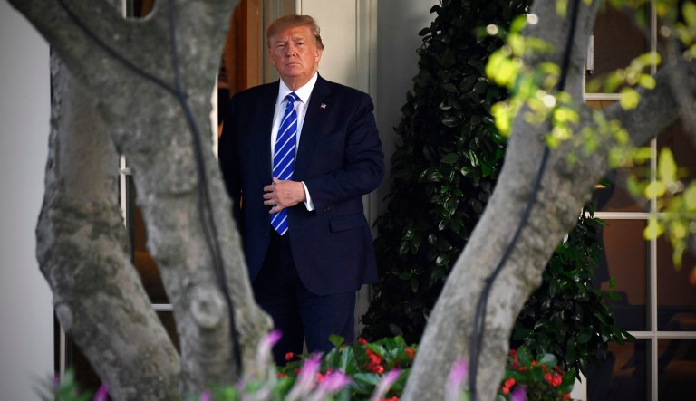 President Trump walks from the Oval Office as he walks to speak with reporters on the South Lawn of the White House in Washington, Friday, before heading to Camp David for the weekend.