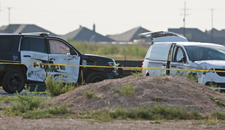 A city of Odessa police car, left, and a U.S. mail vehicle, right, which were involved in Saturday's shooting, are pictured outside the Cinergy entertainment center, Sunday, Sept. 1, 2019, in Odessa, Texas. 