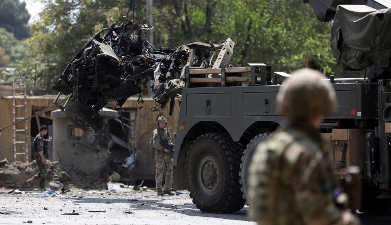 Resolute Support forces remove a destroyed vehicle after a car bomb explosion in Kabul, Afghanistan, Thursday. The Afghan government says at least 10 civilians are dead and another 42 wounded after a Taliban suicide car bombing rocked the Afghan capital near a neighborhood housing the U.S. Embassy and the NATO Resolute Support mission. 
