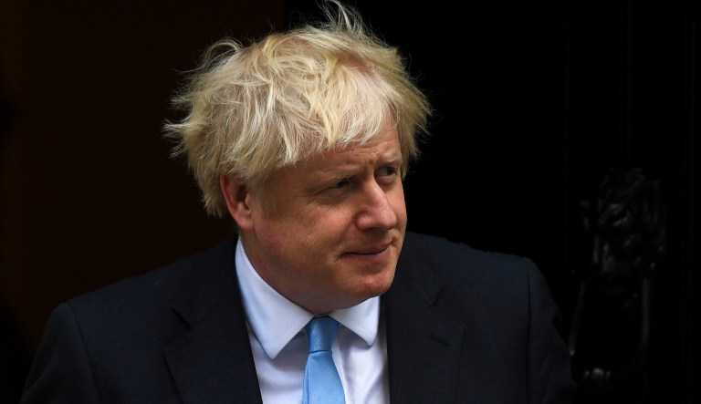 Britain's Prime Minister Boris Johnson walks out of 10 Downing St. to greet Vice President Mike Pence.